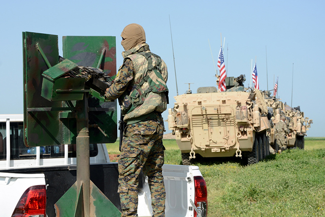 epa07274791 (FILE) - A convoy of US army troops (R) and the People's Protection Units (YPG) Kurdish militia (L) patrol near al-Ghanamya village, al-Darbasiyah town at the Syrian-Turkish border, Syria, 29 April 2017 (reissued 11 January 2019). The US-led military coalition in Syria has begun the process of withdrawing troops from Syria, a US military official said according to media reports on 11 January 2019.  EPA/YOUSSEF RABIE YOUSSEF