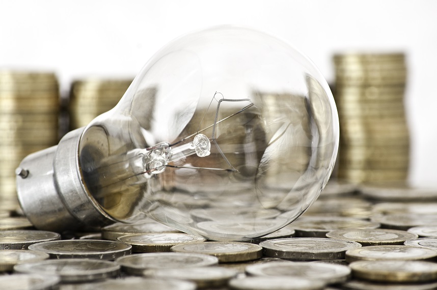 filament bulb lying on euro coins